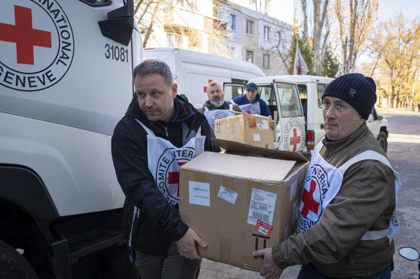 ICRC team delivering relief items pillars