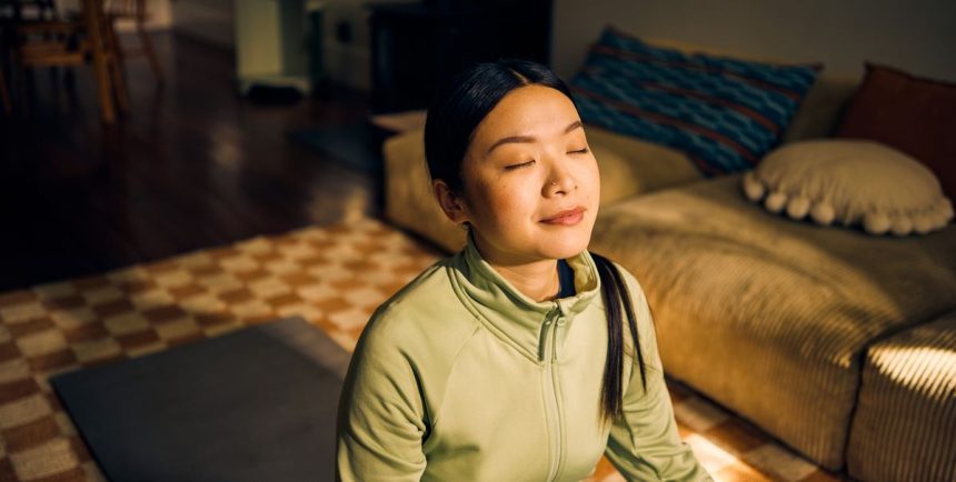 young asian woman meditating in living room indoor royalty free image 1738697731.pjpeg