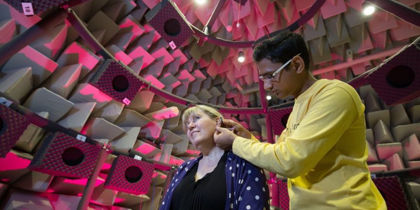soundproof room with foam panels two people working with audio equipment
