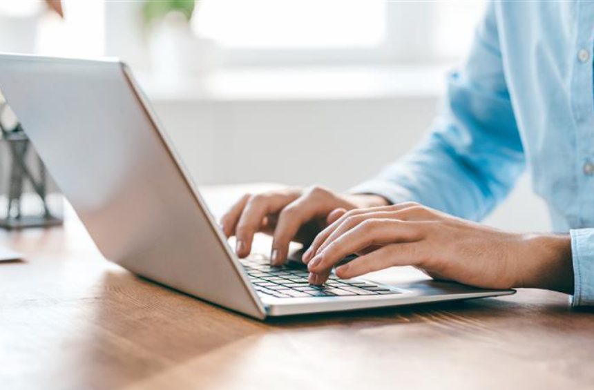 Typing on laptop