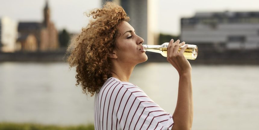 portrait of smiling woman drinking from glass royalty free image 1749673192.pjpeg