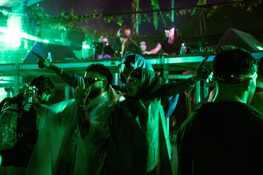 Crowd dancing in the rain at III Points 2023 at Mana Wynwood in Miami