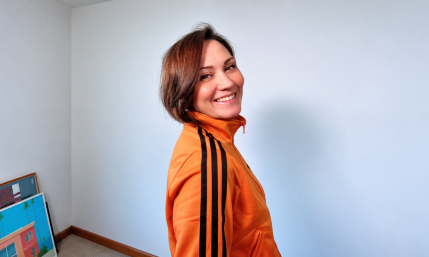 Smiling in a Vibrant Orange Track Jacket 1000x600